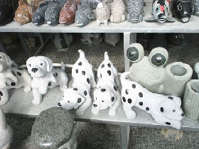 Stone small dogs with black spots